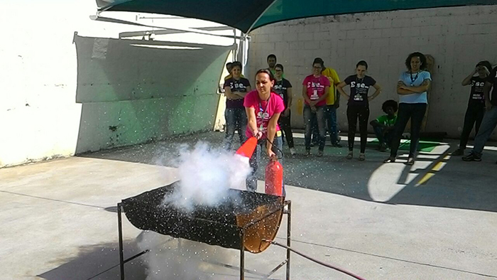 Colaboradora apaga chamas com extintor de incêndio